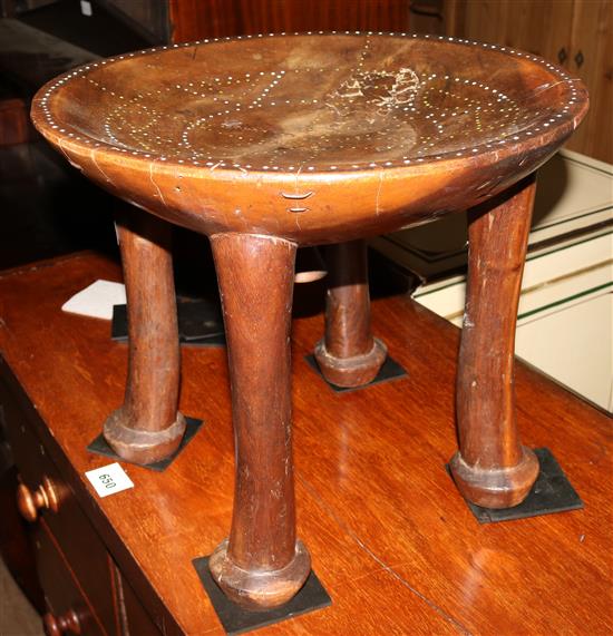 A West African tribal hardwood and beadwork stool(-)